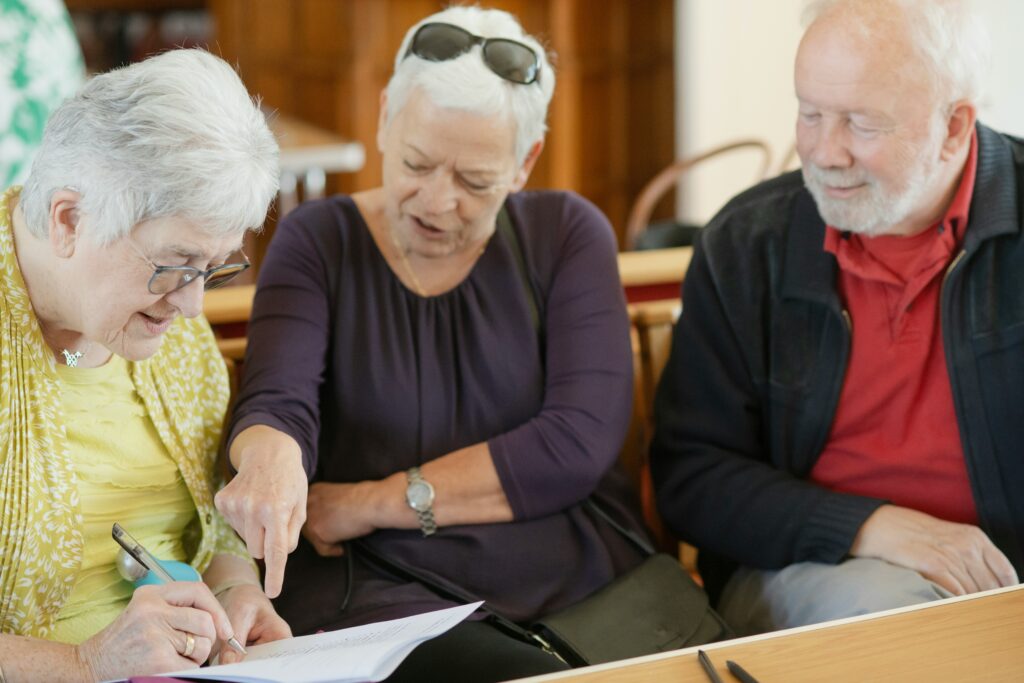 Adult children and aging parent in conversation about family financial planning