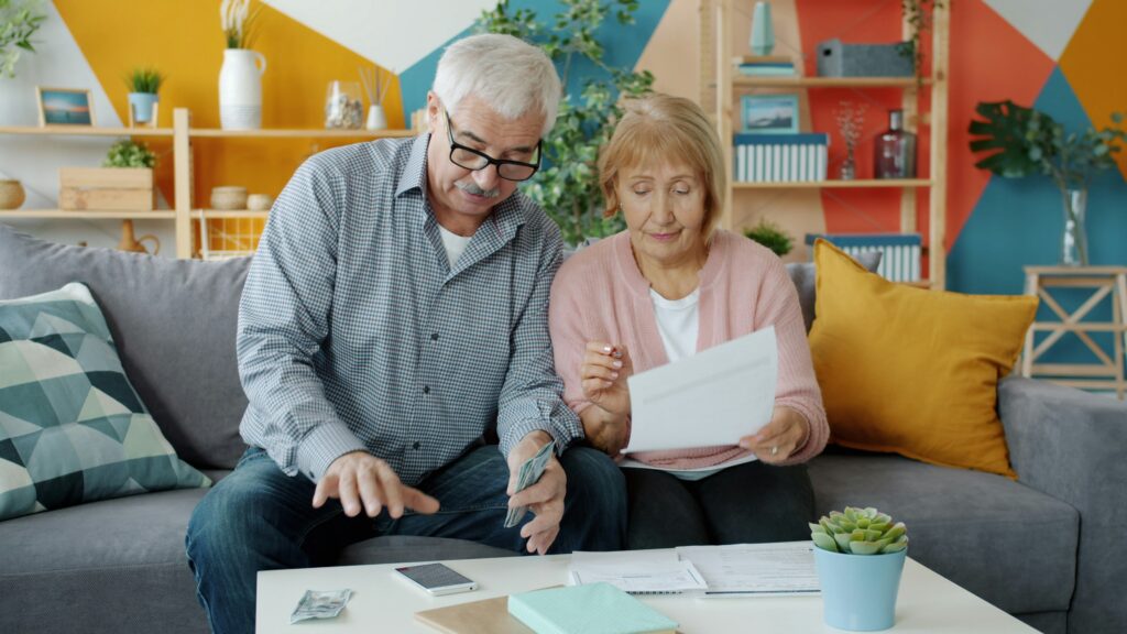 Senior policyholder reviewing life insurance policy options at home